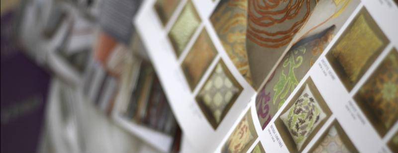 Printed product catalogue pages showing embroidered cushion designs, designed by Starfish